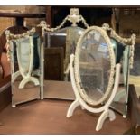 A white and gilt three part folding dressing mirror, with bell flower swags; together with a small