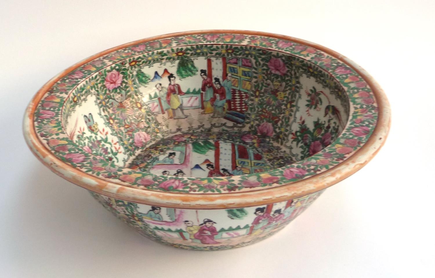 A large Chinese famille rose punch bowl, interior decorated with panels of court scenes and flora