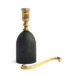 A brass candle holder with hole for ejecting candle, on a painted oak base, 21cm high; together