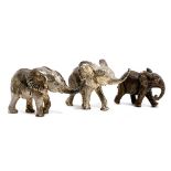 Two small white metal elephants, made in Zimbabwe, and one small bronze elephant, the largest 3.5cmH