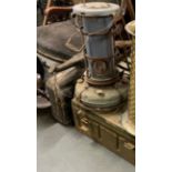 An ammunition box, vintage oil heater and jerry can