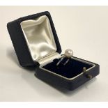 A French Art Deco platinum and pearl ring, the scrolling shoulders set with diamonds, size Q,