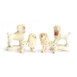 Two pairs of 19th century Staffordshire 'lion clipped' poodles, one matched pair holding baskets