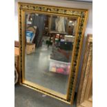 A gilt framed and painted grape and vine mirror, with bevelled glass, 108x76cm