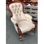 A Victorian buttonback salon armchair, scrolling arms on baluster turned legs, 68cmW