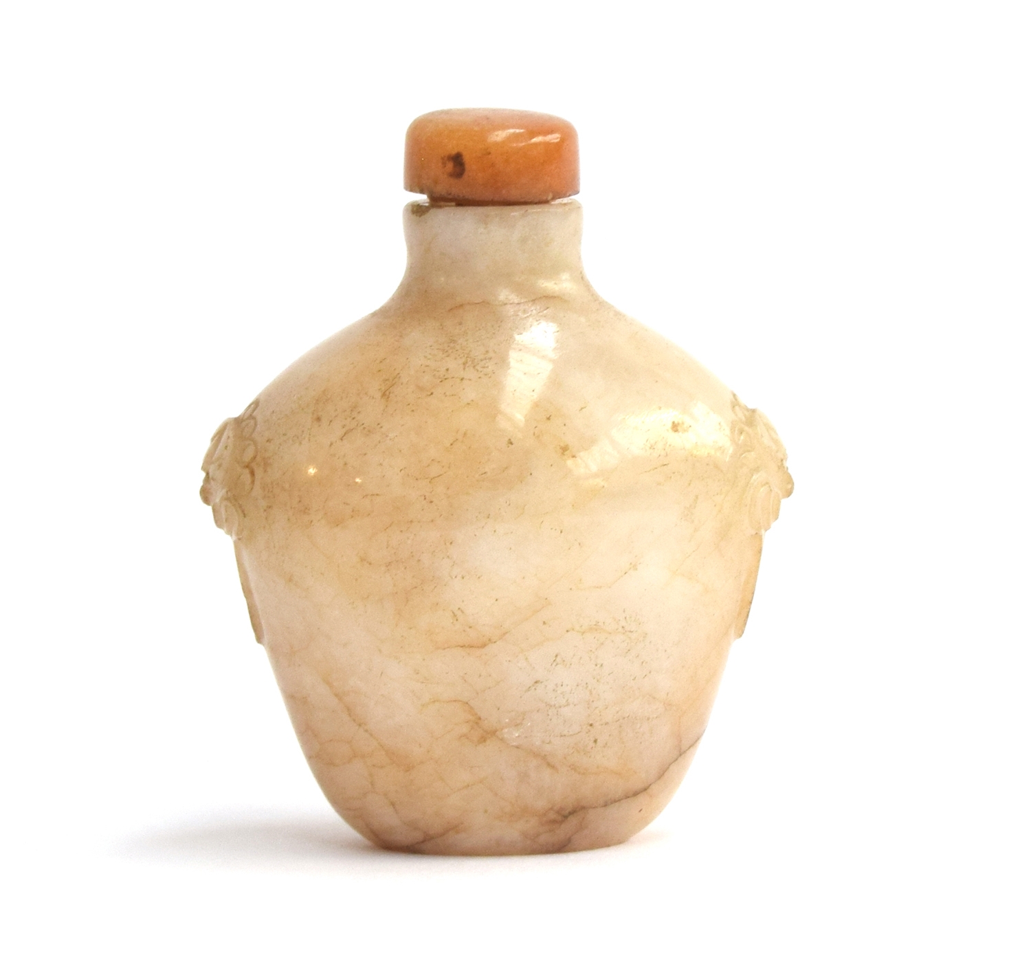 A Chinese white and russet jade snuff bottle, flattened ovoid form and carved mask handles, with