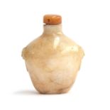 A Chinese white and russet jade snuff bottle, flattened ovoid form and carved mask handles, with