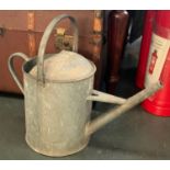 A large galvanised vintage watering can