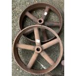 Two cast iron wheels, the larger 30cmD