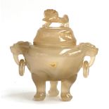 A Chinese hardstone censer with twin handle dragon lugs and lid surmounted by foo dog, 11.5cmH