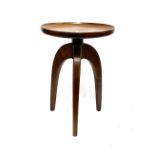 A contemporary three legged circular table, with dished top, 40x55.5cmH
