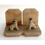 A pair of quartz crystal book ends, each with cold painted terriers, 9cmH