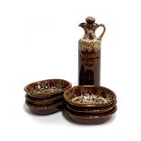 A Foster's pottery oil bottle and six bowls