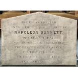 A marble plaque reading 'The organ erected in this church was the gift of Napoleon Bonnett of