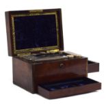 A Victorian rosewood and brass bound fitted travelling vanity box, the lid with crumpled velvet