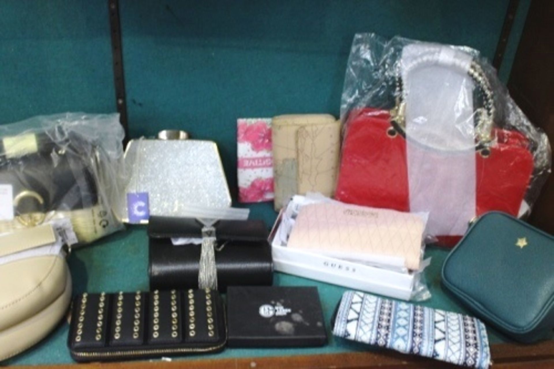 A quantity of high street branded handbags and purses including Guess purse, V Bags, New Look