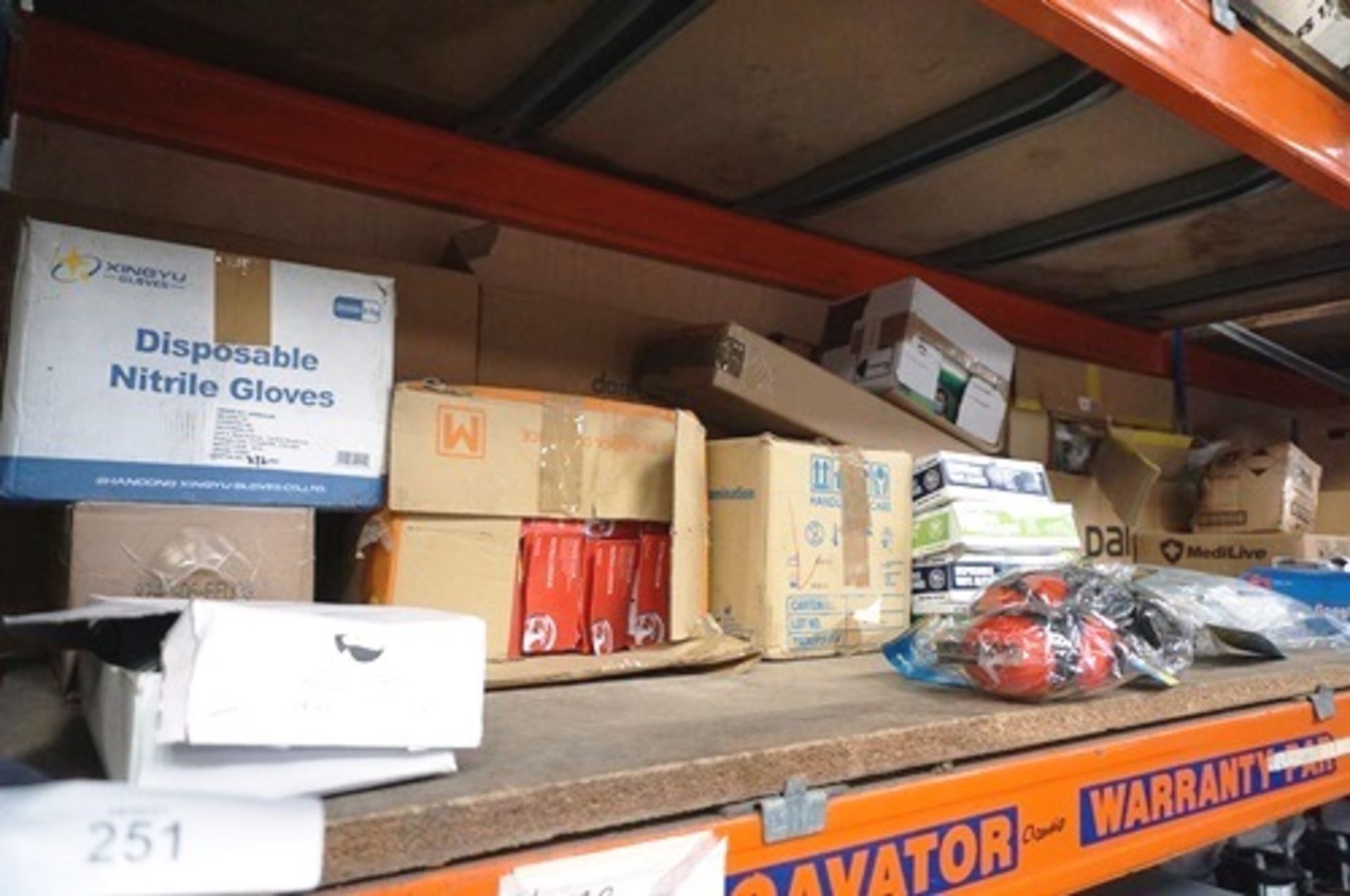 A shelf of workplace safety/hygiene equipment including gloves , ear defenders, goggles etc. -