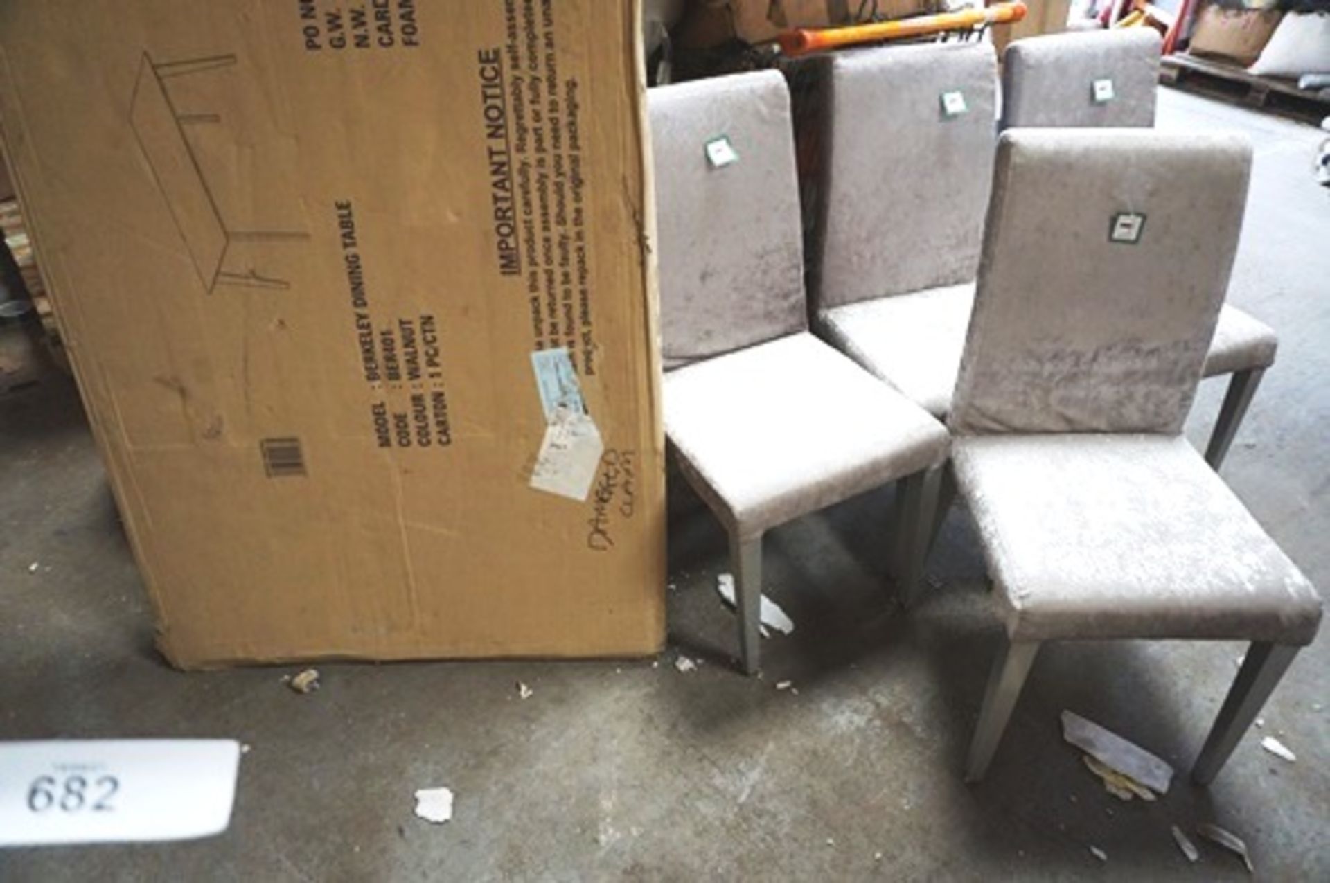 A set of 4 grey fabric upholstered dining chairs, 1 missing foot and has a slightly bent leg,