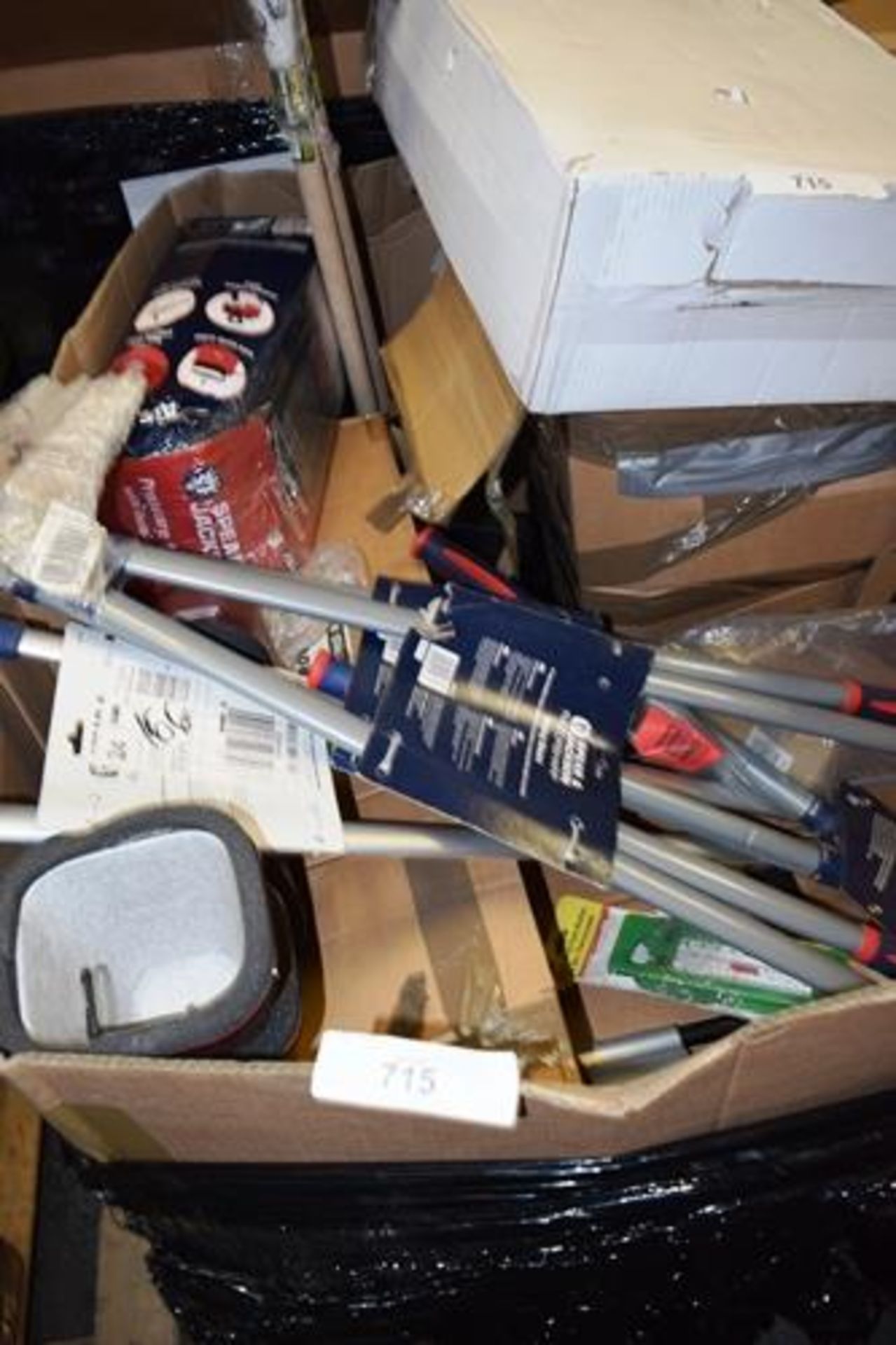 A pallet of assorted gardening equipment including wheel barrows, oscillating sprinkler tap covers