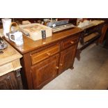 An oak effect cupboard fitted two drawers