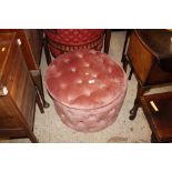 A pink upholstered ottoman; and a red upholstered