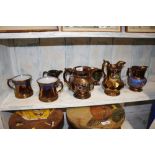 A quantity of 19th Century copper lustre jugs and mugs