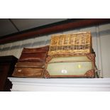 Three vintage suitcases and a wicker hamper