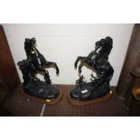 A pair of black painted spelter Marley horses