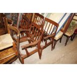 A set of six teak dining chairs lacking seats