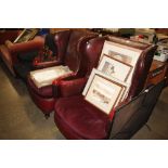 A pair of red leatherette wing back armchairs for rest