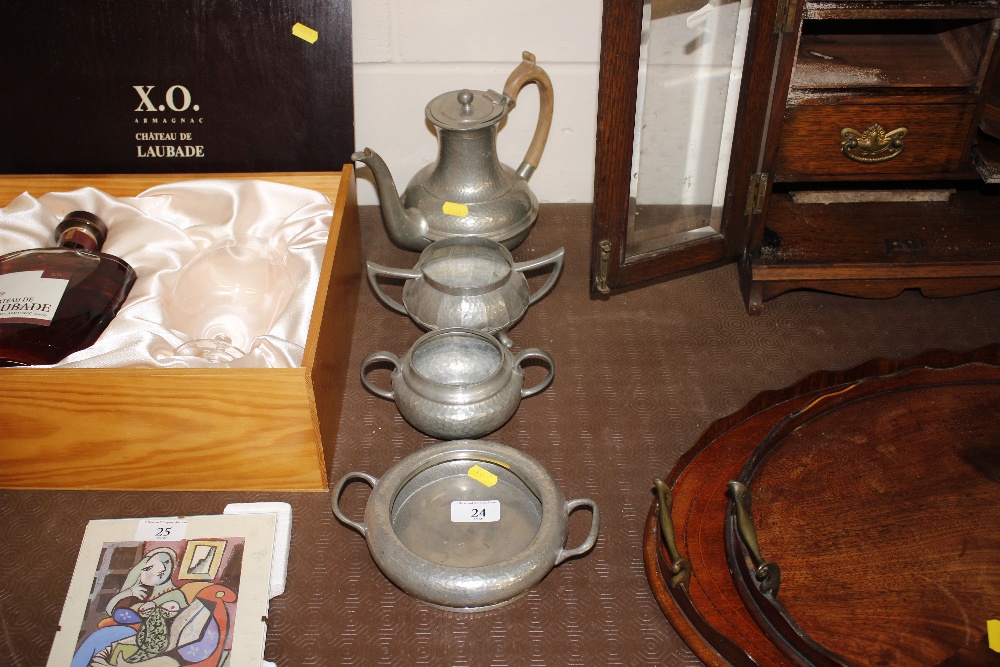 A pewter spot hammered three piece teaset; and a s