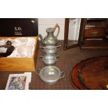 A pewter spot hammered three piece teaset; and a s