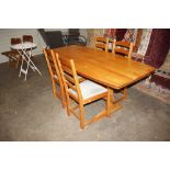 A teak kitchen dining table and four matching ladd