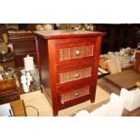 A bedside chest fitted three drawers