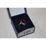 A silver and red stone set ring