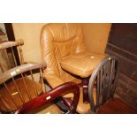 A leather swivel chair with matching foot stool