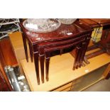 A nest of three reproduction mahogany occasional t