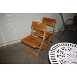 Two wooden folding chairs