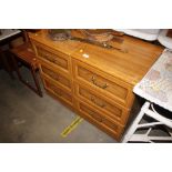 A pair of bedside chests fitted three drawers