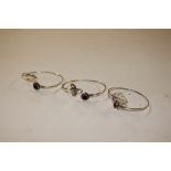 Three silver hard stone set bangles