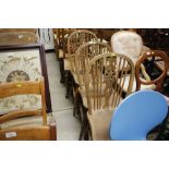 A set of three stick and wheel back dining chairs