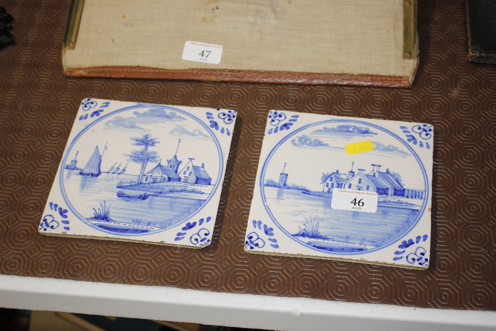 Two antique Delft tiles depicting church and other