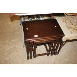 An oak nest of three coffee tables