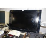 A Sony wall mounted television lacking brackets an