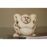 A carved ivory Netsuke in the form of a contortion
