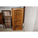 A modern stripped pine hanging corner cupboard