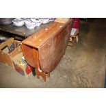 A teak drop leaf dining table