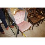 A pink upholstered nursing chair