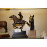 A bronzed figure of a polo player and horse, bears