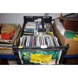 A crate containing various CDs; cassette tapes etc